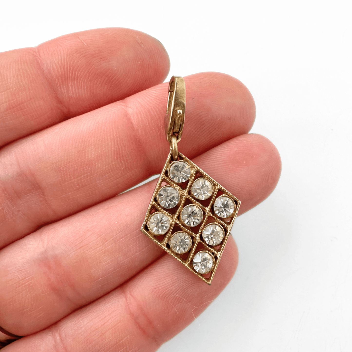 Vintage clear rhinestone diamond-shaped charm with gold tone setting and brass lobster clasp