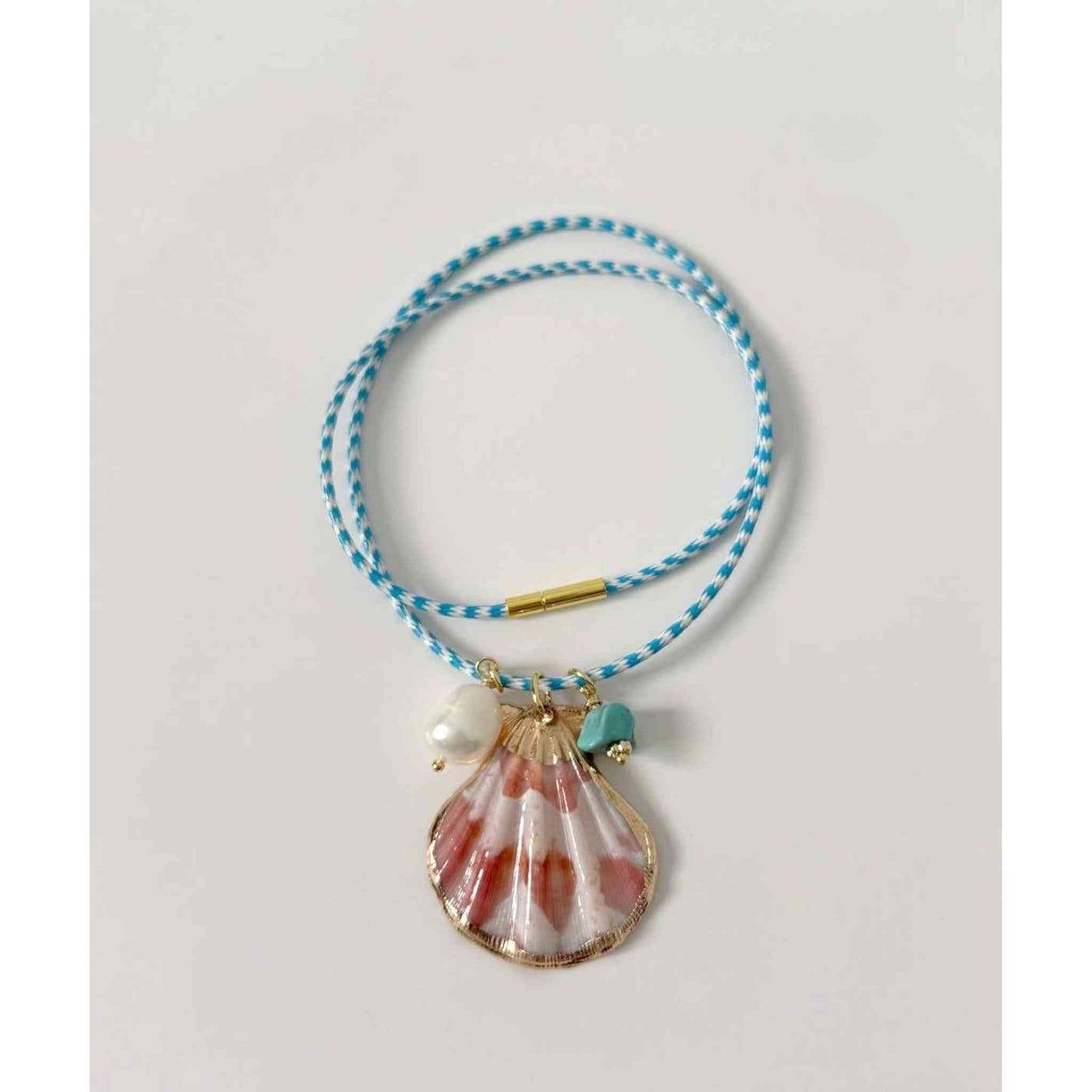 Islas Shell Necklace with gold plated shell, freshwater pearl, turquoise charm on blue and white cord, 16-inch length