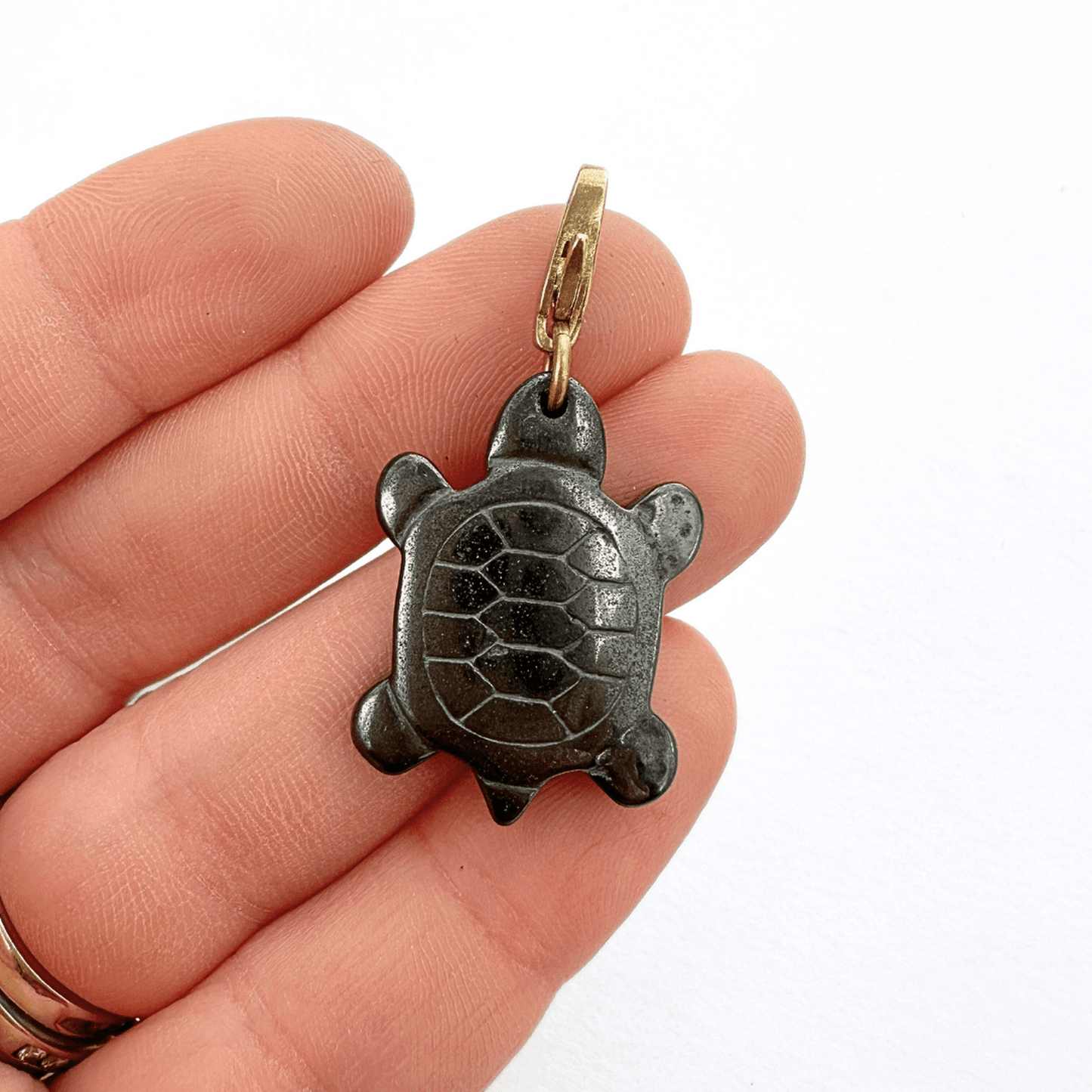 Vintage carved hematite turtle charm with brass lobster clasp in deep charcoal color