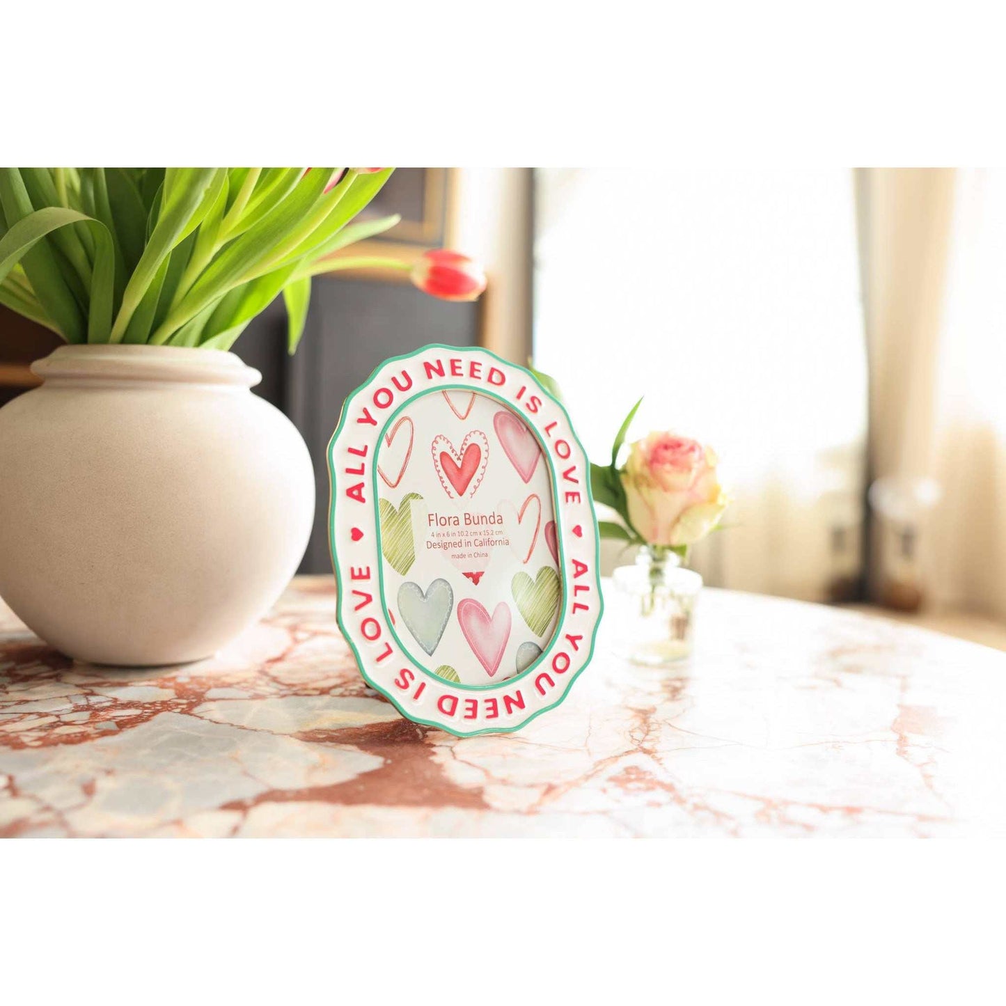 
                  
                    All You Need Is Love ceramic heart photo frame with colorful watercolor hearts and scalloped border
                  
                