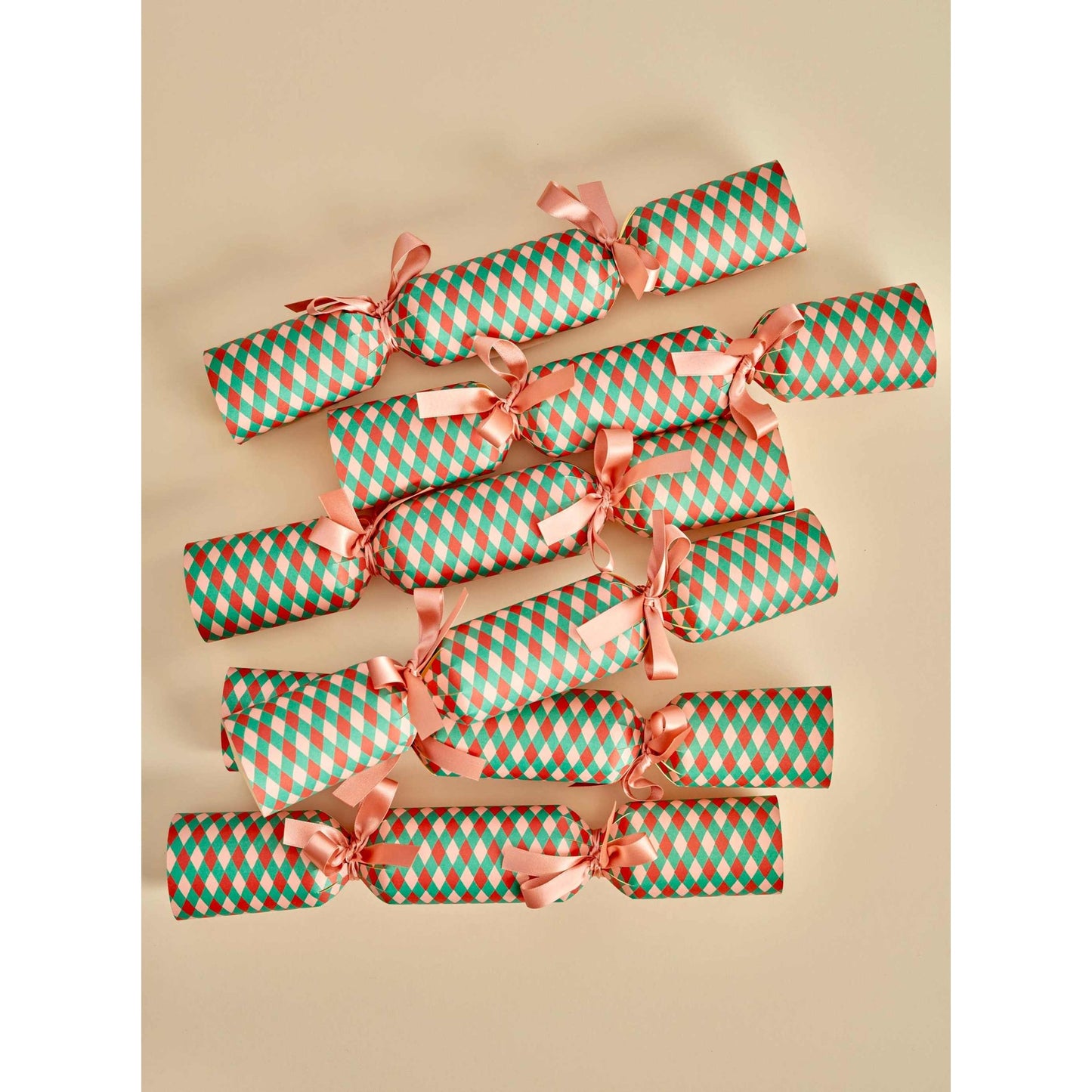 Set of six DIY harlequin print holiday cracker kits with ribbons, ready for assembly and decoration