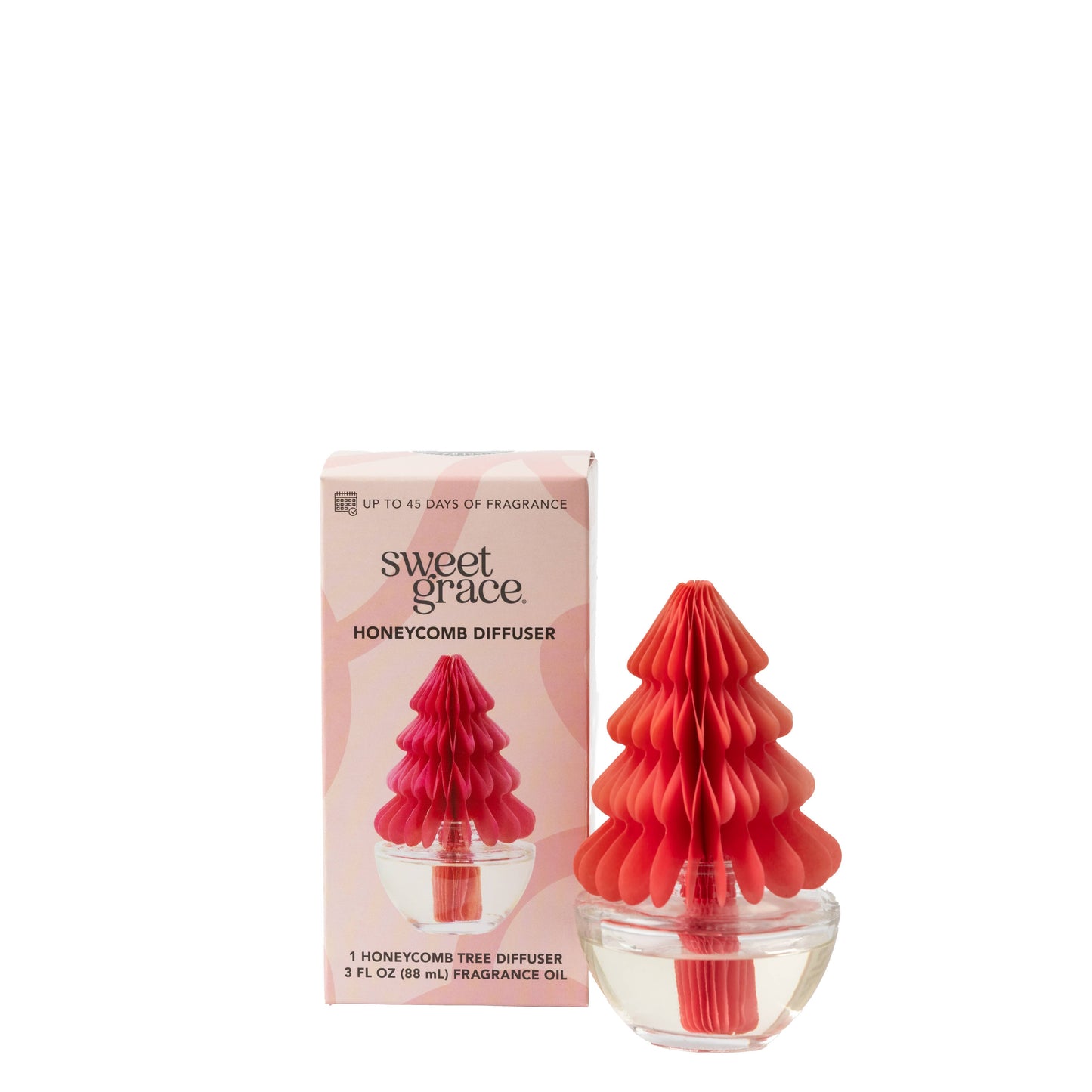 Sweet Grace Honeycomb Diffuser with pink paper tree and clear glass vase releasing festive fragrance