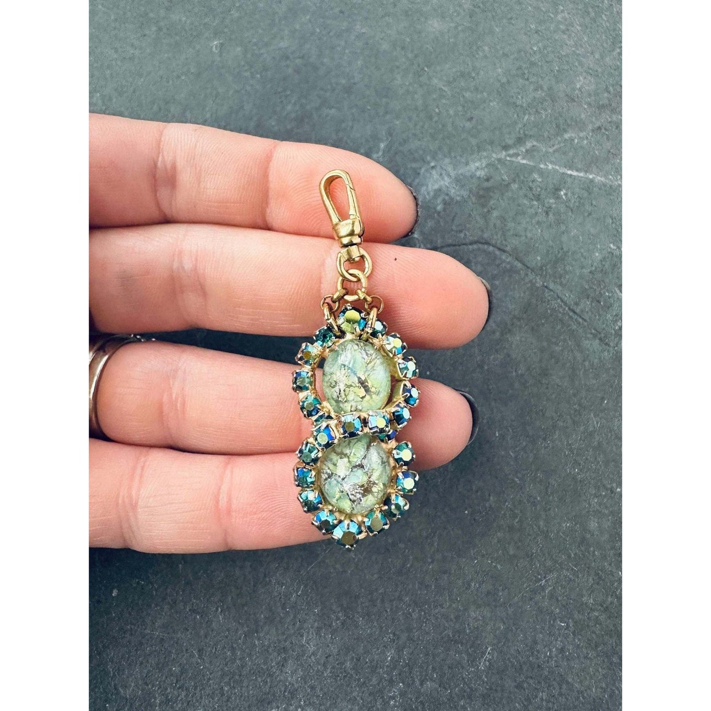 Vintage green rhinestone charm with iridescent blue stones and raw brass swivel clasp