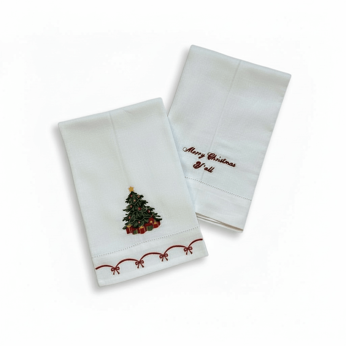 
                  
                    Christmas embroidered linen guest towels with tree, presents, and "Merry Christmas Y'all" script designs
                  
                