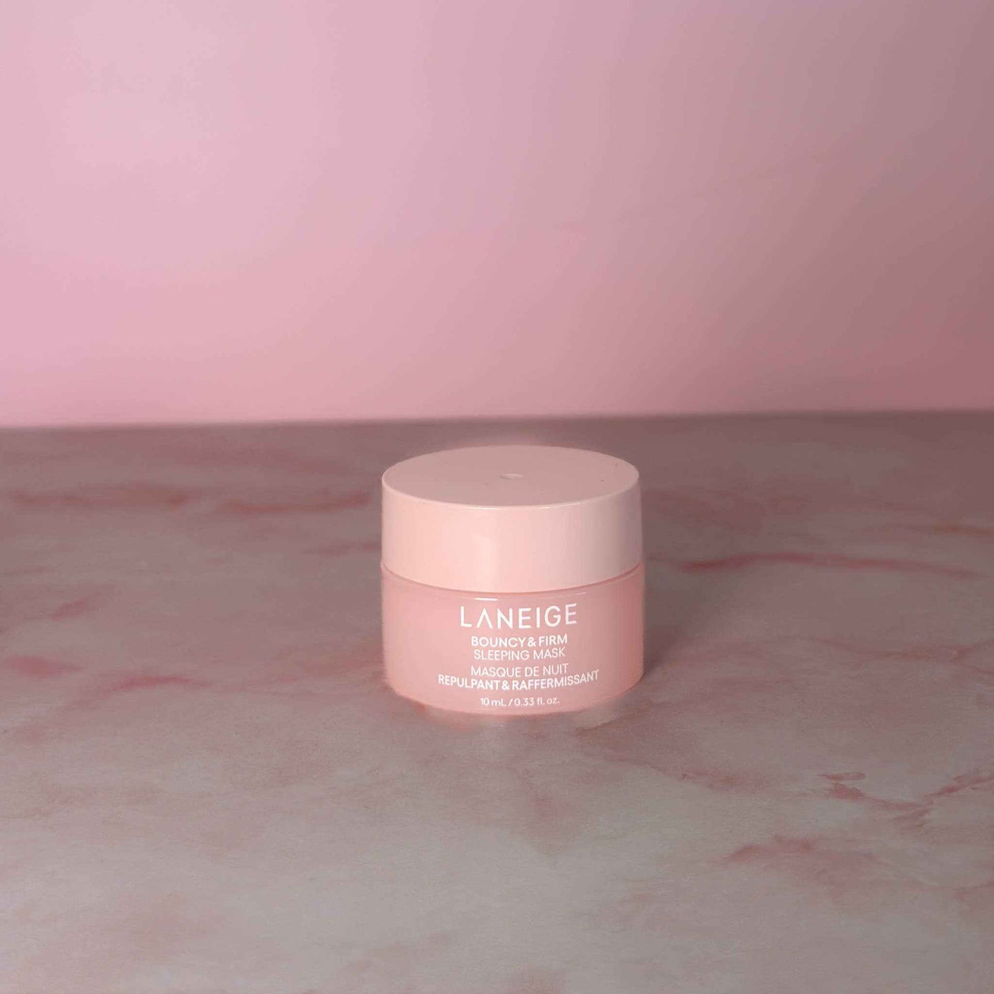 LANEIGE MINI Bouncy & Firm Sleeping Mask collagen eye treatment jar with spoon on blue background