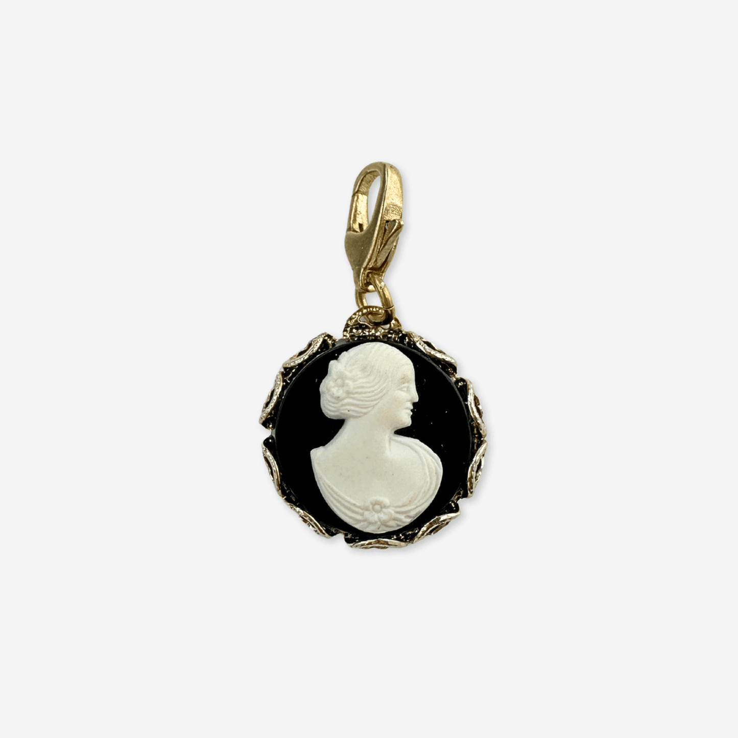 Vintage black and white acrylic cameo charm in gold tone lace-edge setting with raw brass lobster clasp