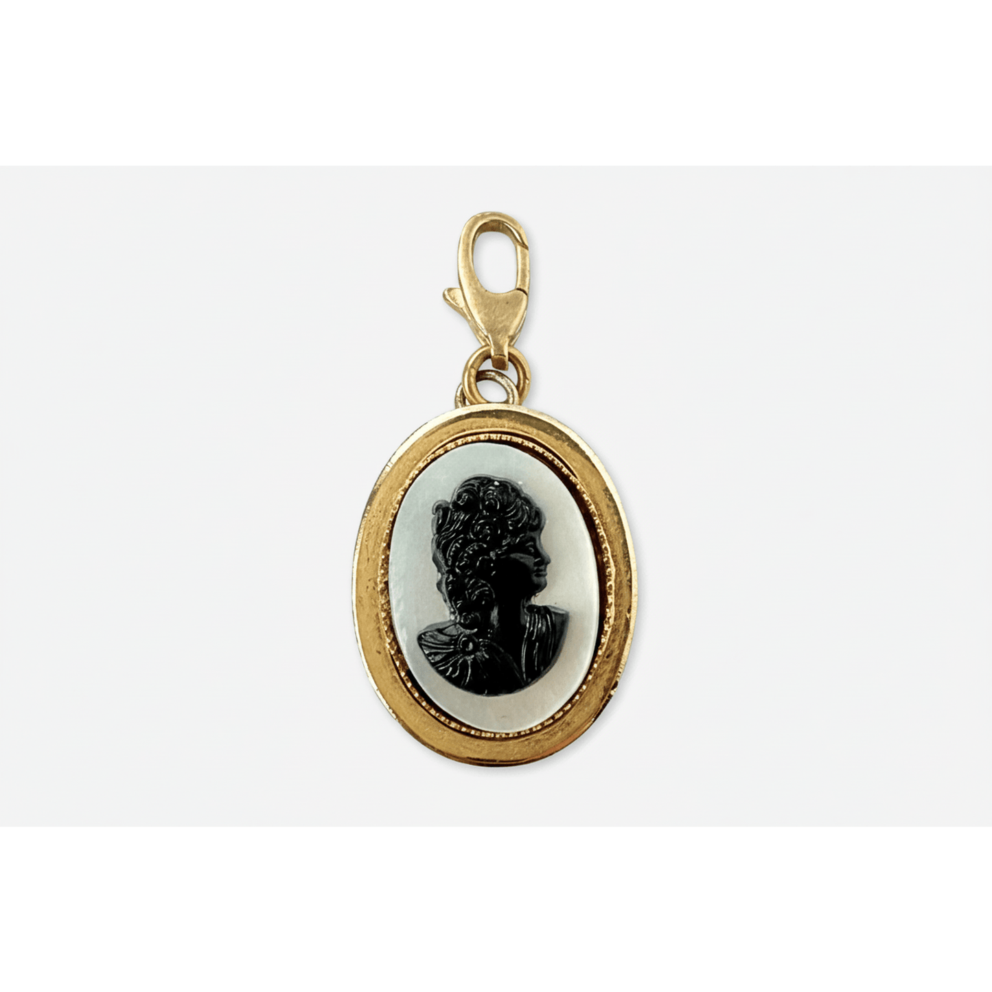 Vintage oval mother of pearl cameo charm with black acrylic in gold frame and brass clasp