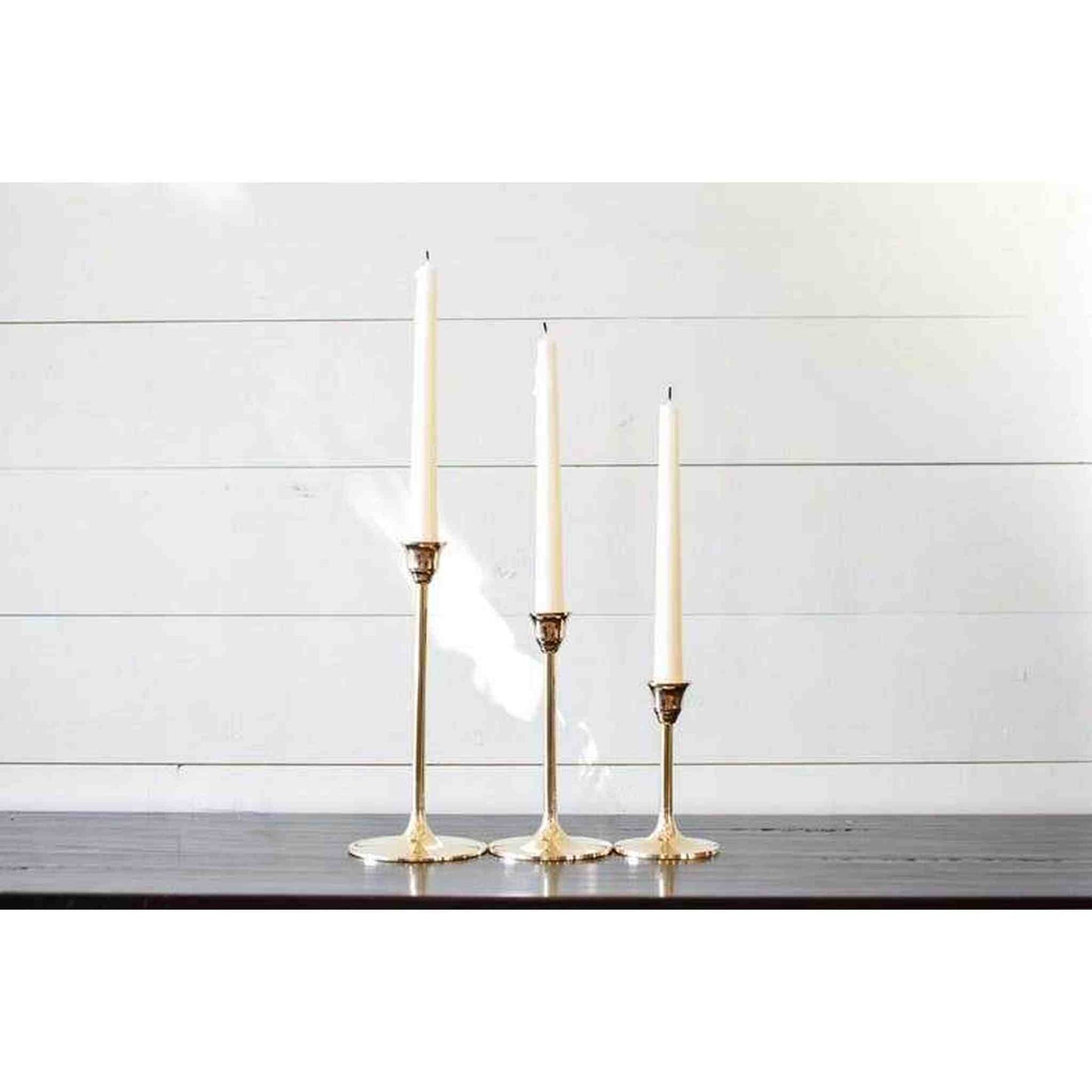 
                  
                    A set of three brass candlesticks. - Curated Home Decor
                  
                
