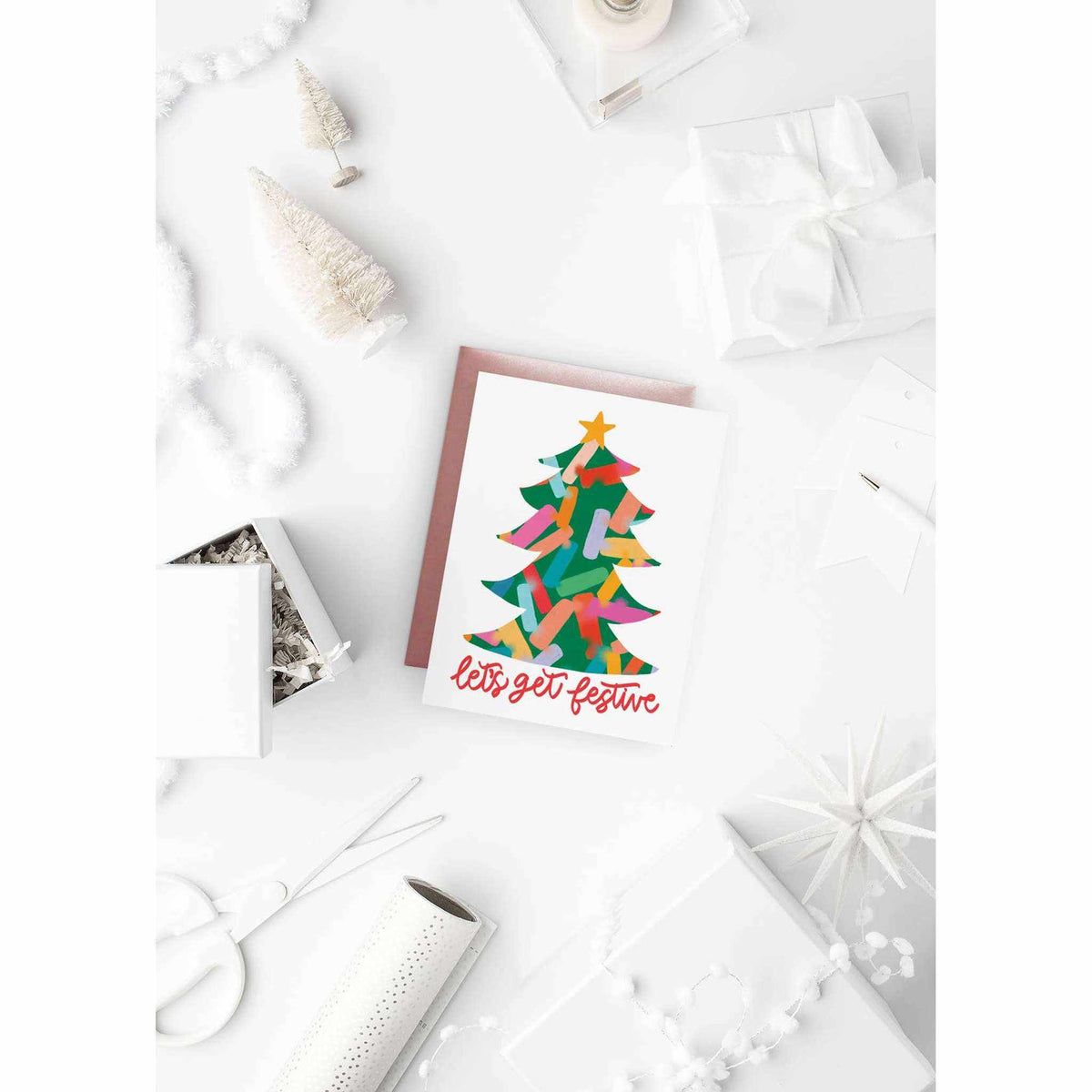 Festive Tree Card with colorful Christmas tree and "let's get festive" text, A2 size holiday greeting card with pink envelope on white background