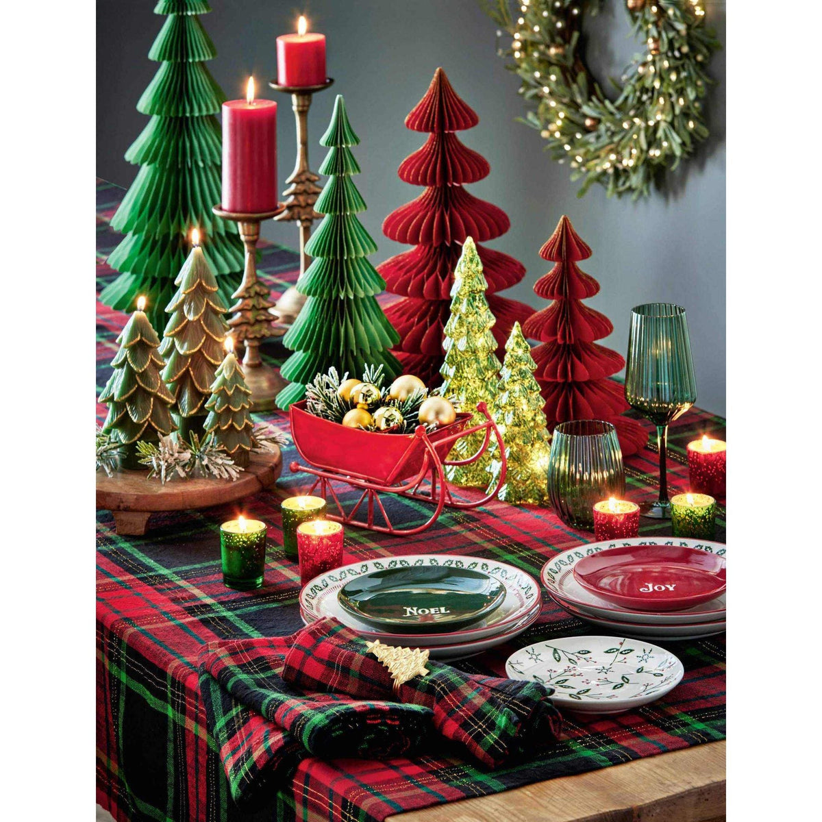 
                  
                    Christmas Glimmer Paper Tree Décor in red with gold glitter accents on festive holiday table setting
                  
                