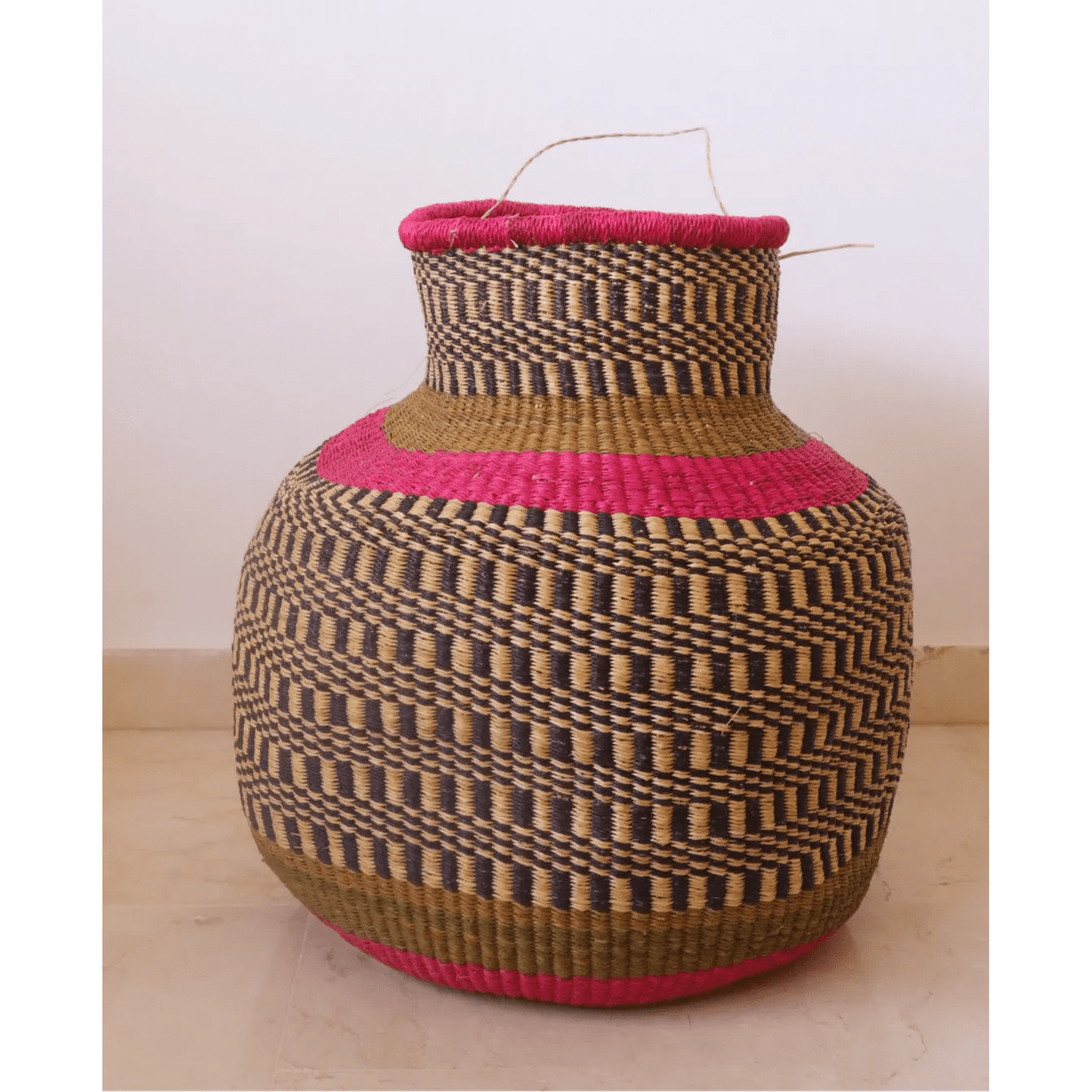 Pink round African decor basket handwoven from vetiver leaf in Burkina Faso