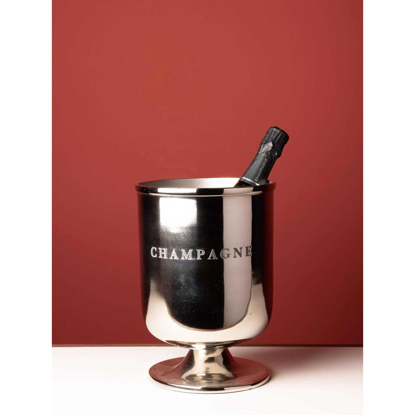 Champagne bucket on coordinated round metal stand for elegant beverage chilling and entertaining