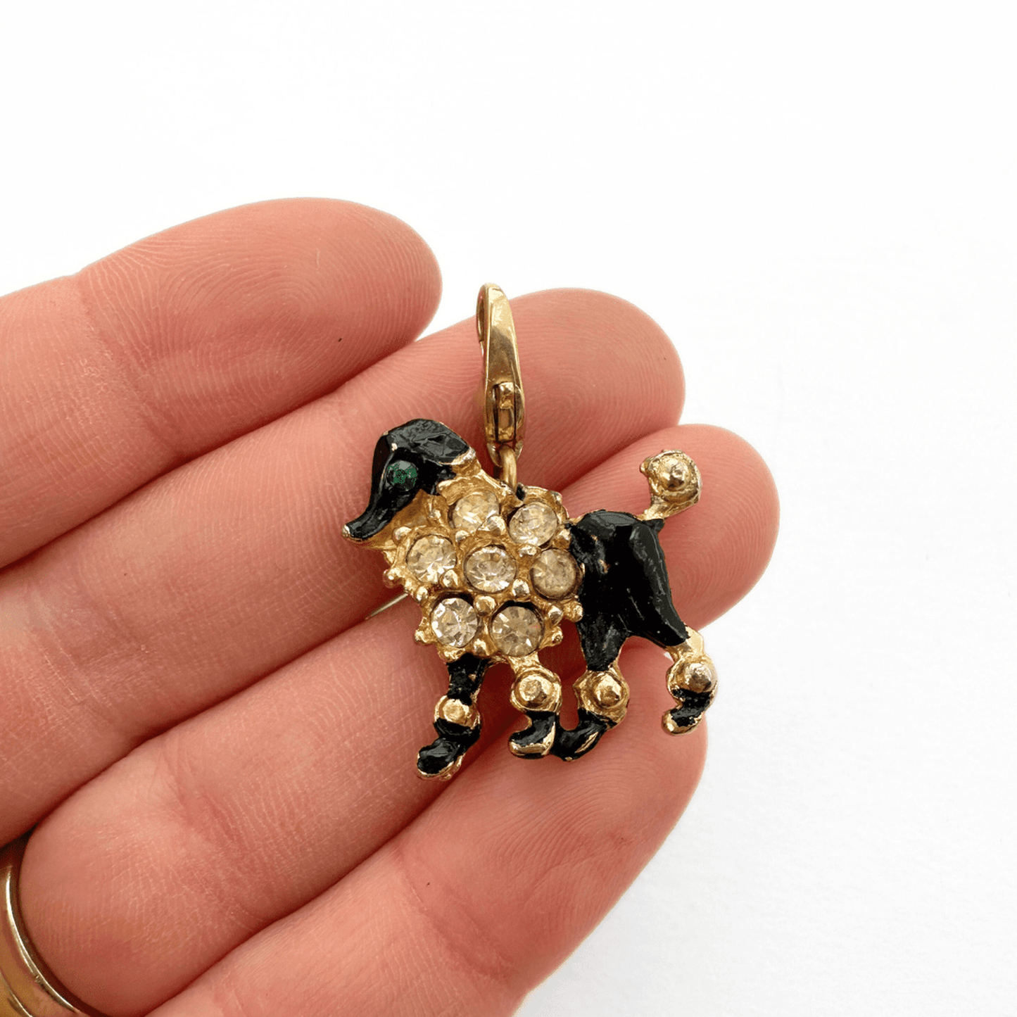 Vintage gold and black rhinestone poodle charm with green rhinestones and black enamel details on gold tone base