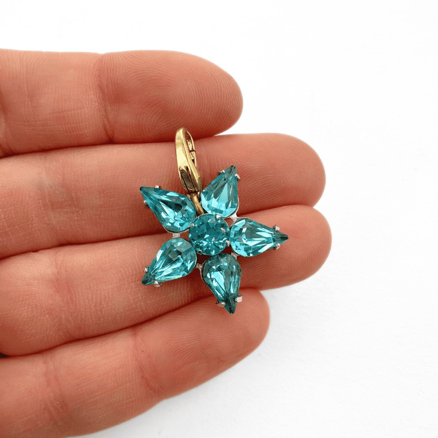 Vintage aqua blue rhinestone star charm with silver-tone setting and brass clasp