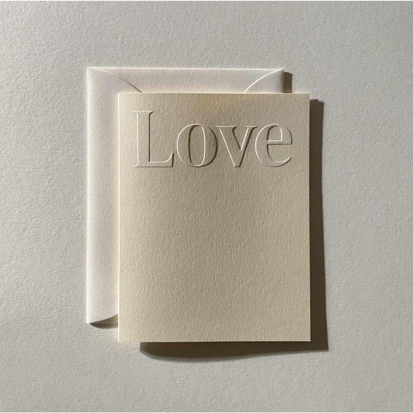 Love No. 19 folded card with creme blind embossed cover and natural envelope