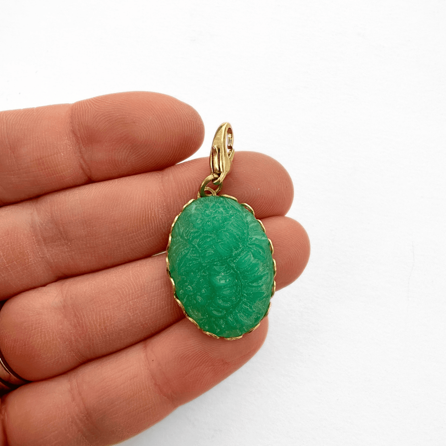 Vintage molded green glass jade oval charm in brass lace setting with lobster clasp