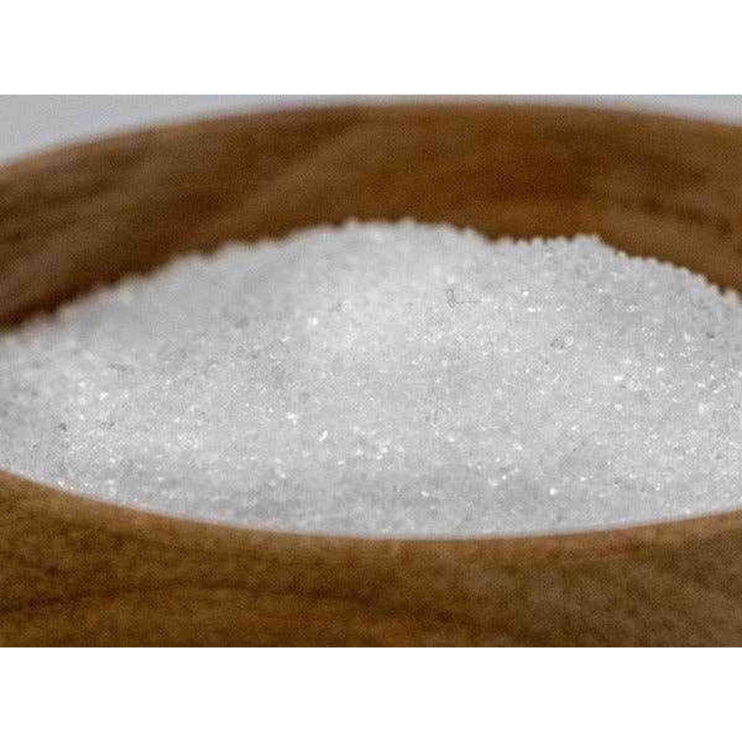 Close-up of white granulated xylitol birch sugar in wooden bowl, low glycemic index sweetener ideal for diabetics and dietary use