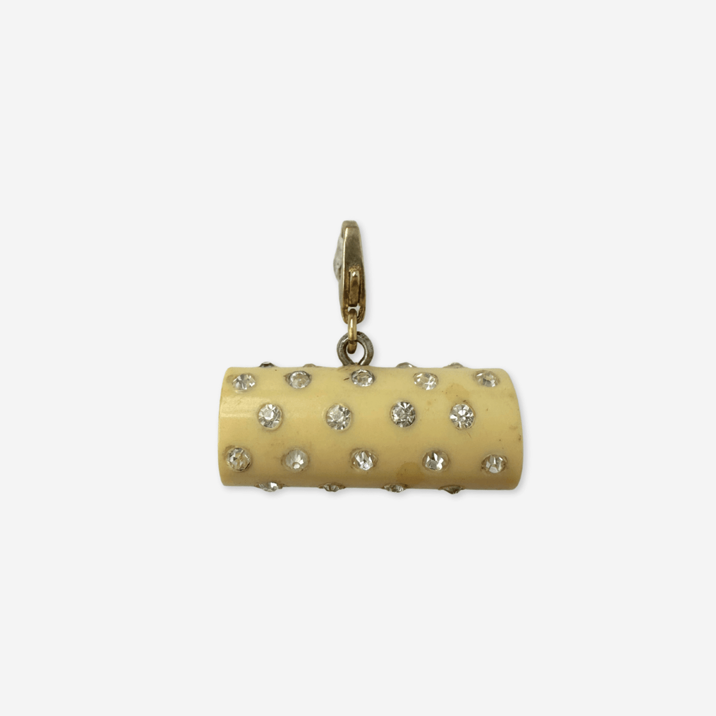 Vintage pale yellow rhinestone celluloid cylinder charm with raw brass clasp