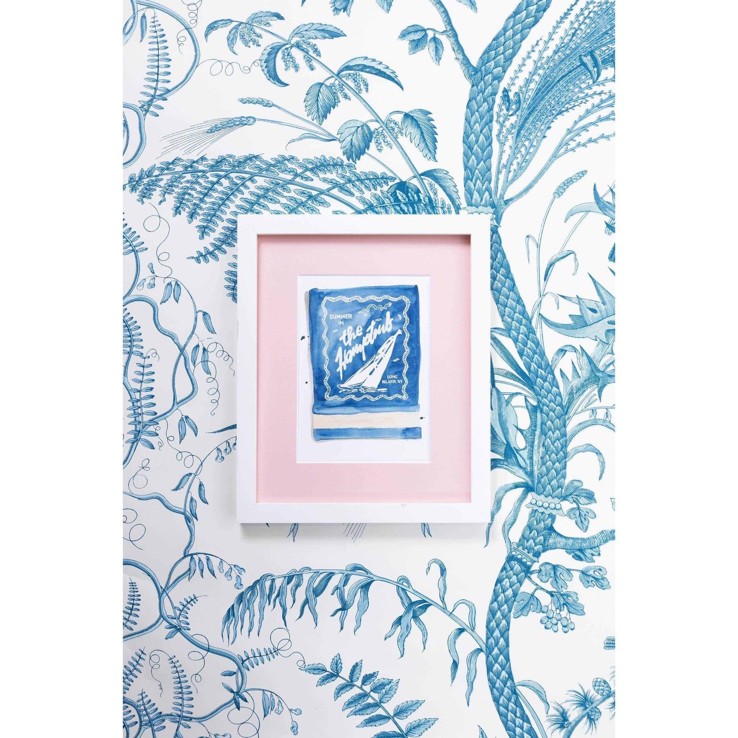 The Hamptons Matchbook watercolor art print in white frame on blue botanical wallpaper background
