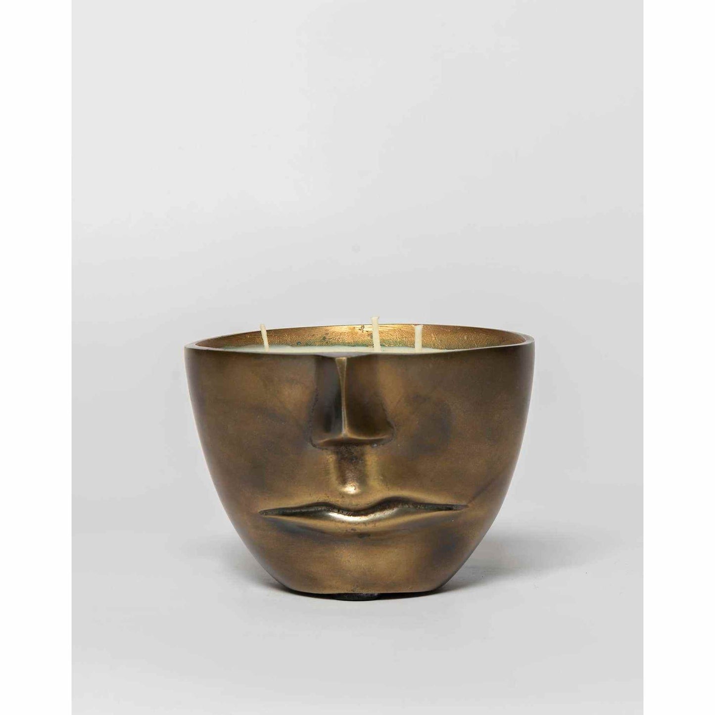 Iron Face Flames & Flannel Soy Candle in cast metal with triple wick and abstract half-face design