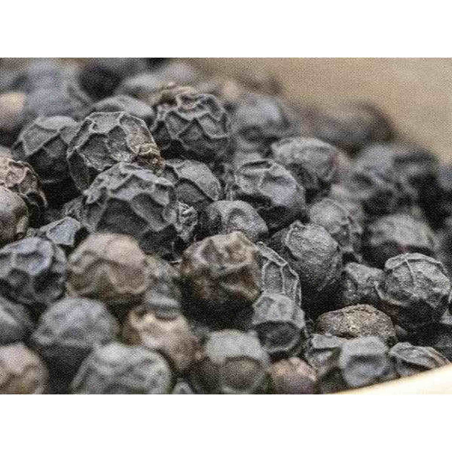 Close-up of aromatic black pepper from Madagascar with wrinkled texture and gourmet notes