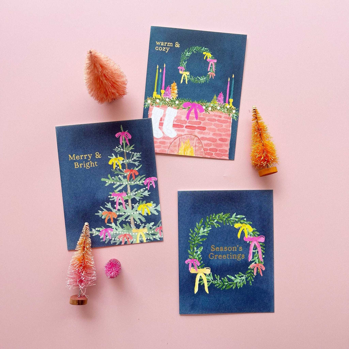 
                  
                    Holiday Mantel Greeting Card set with navy background, gold foil text, watercolor mantel and wreath illustrations, festive holiday decorations.
                  
                
