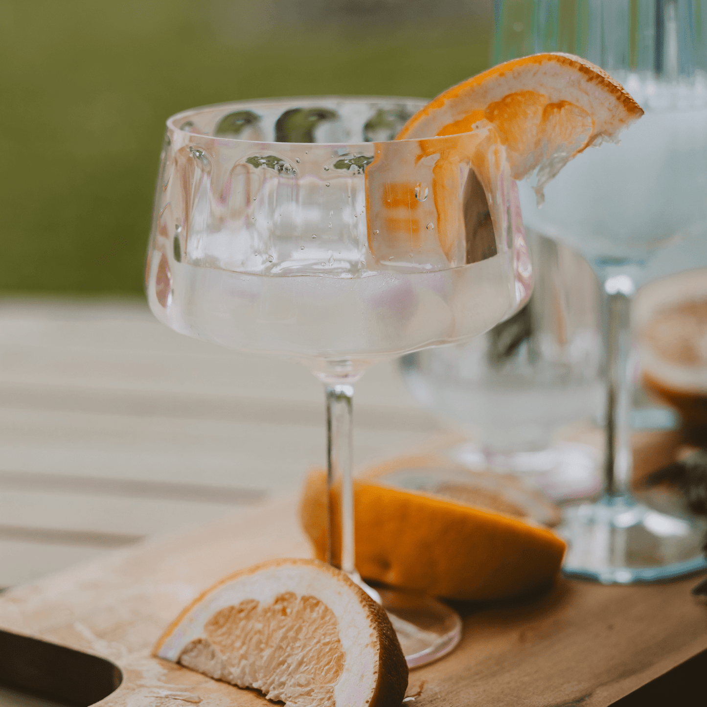 Pink tinted outdoor plastic coupe glass for cocktails, BPA-free and reusable