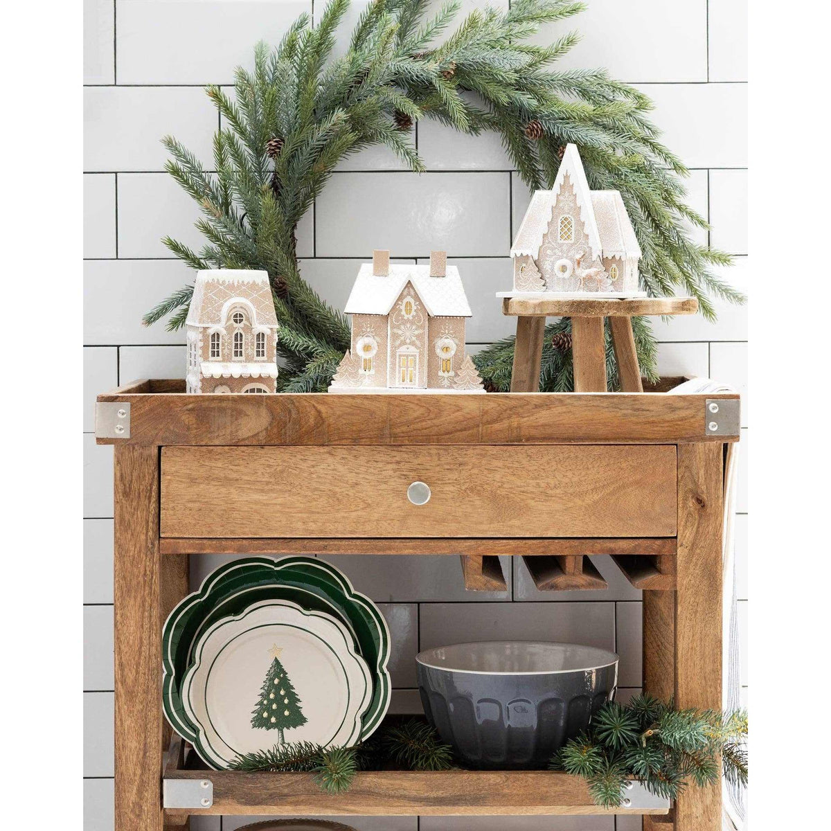 
                  
                    Gingerbread Shop holiday village decor with battery-powered lights and glitter accents on wooden table with festive greenery
                  
                