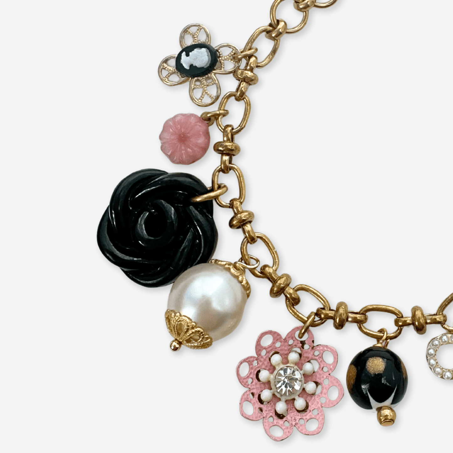 
                  
                    Repurposed vintage pink, black, and white mixed charm bracelet - Curated Home Decor
                  
                