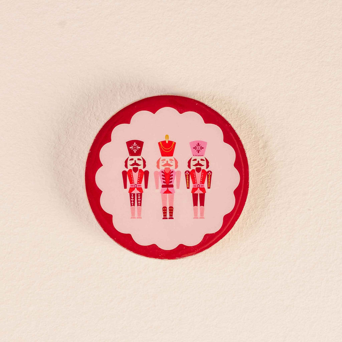 Wood enamel coaster with nutcracker design protecting surfaces from beverages