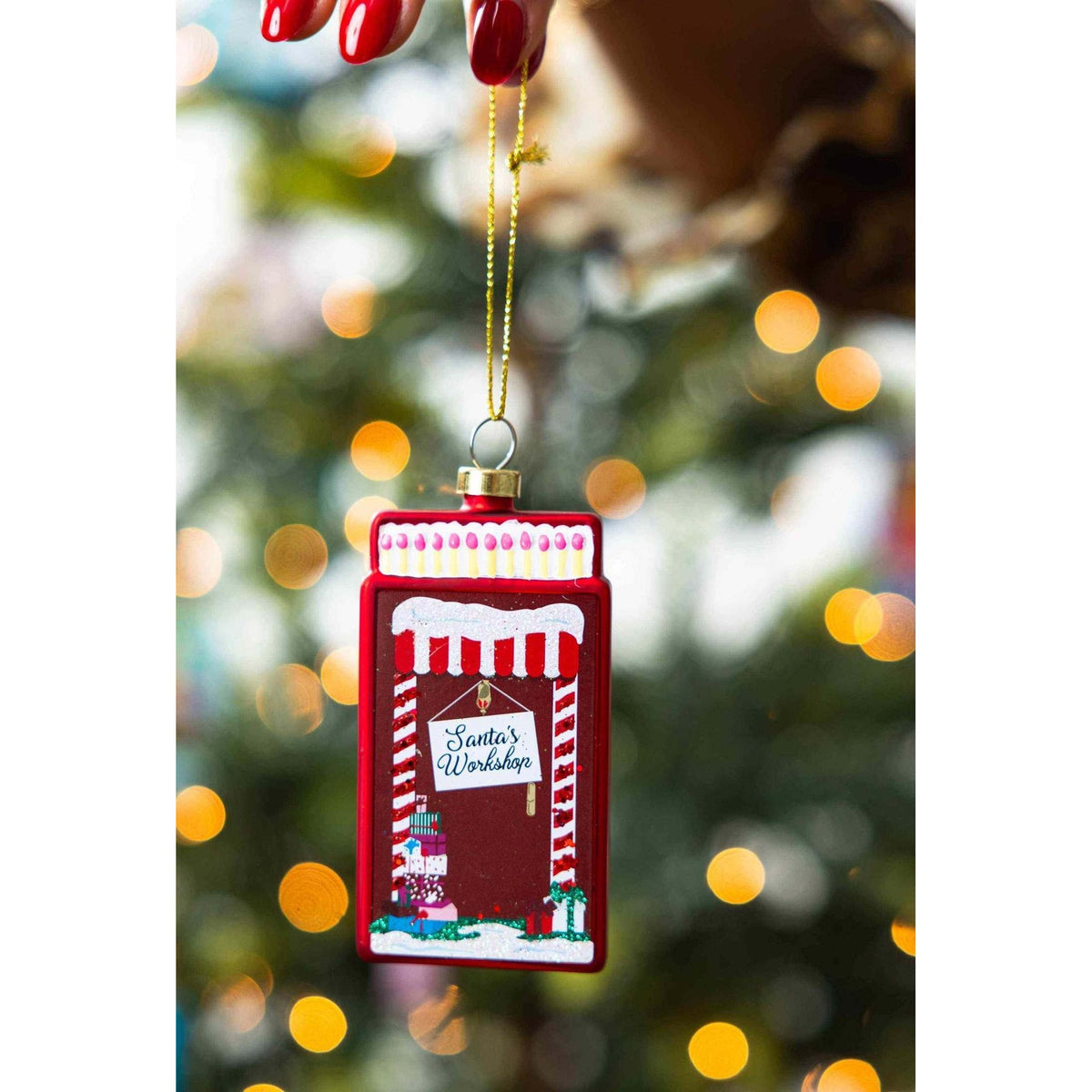 
                  
                    Santa's Workshop Matchbook Ornament glass Christmas tree decoration with festive design and gold hanging string
                  
                