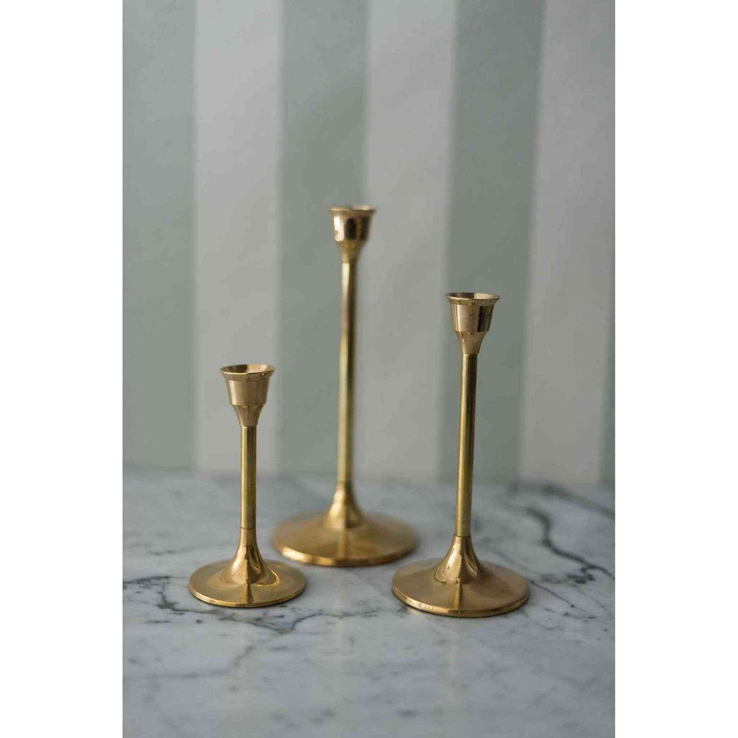 
                  
                    A set of three brass candlesticks. - Curated Home Decor
                  
                