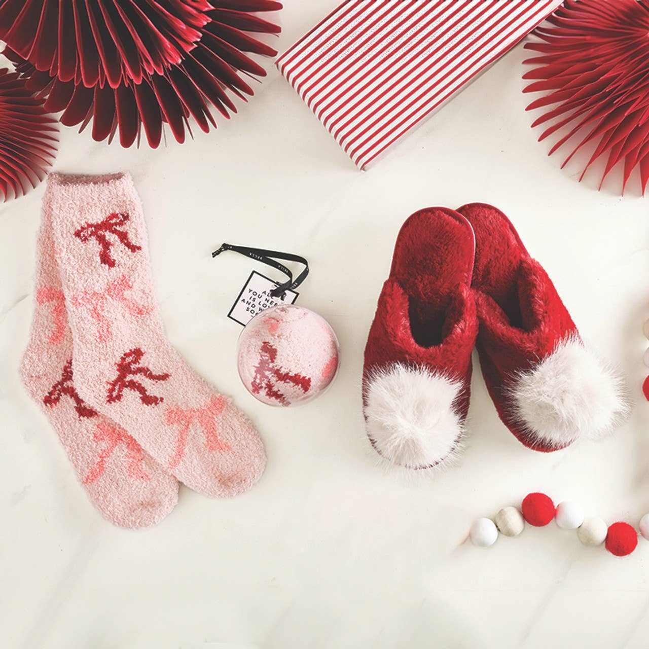 Cozy Socks in Ornament blush pink plush socks with bows and festive red slippers with white pom-poms