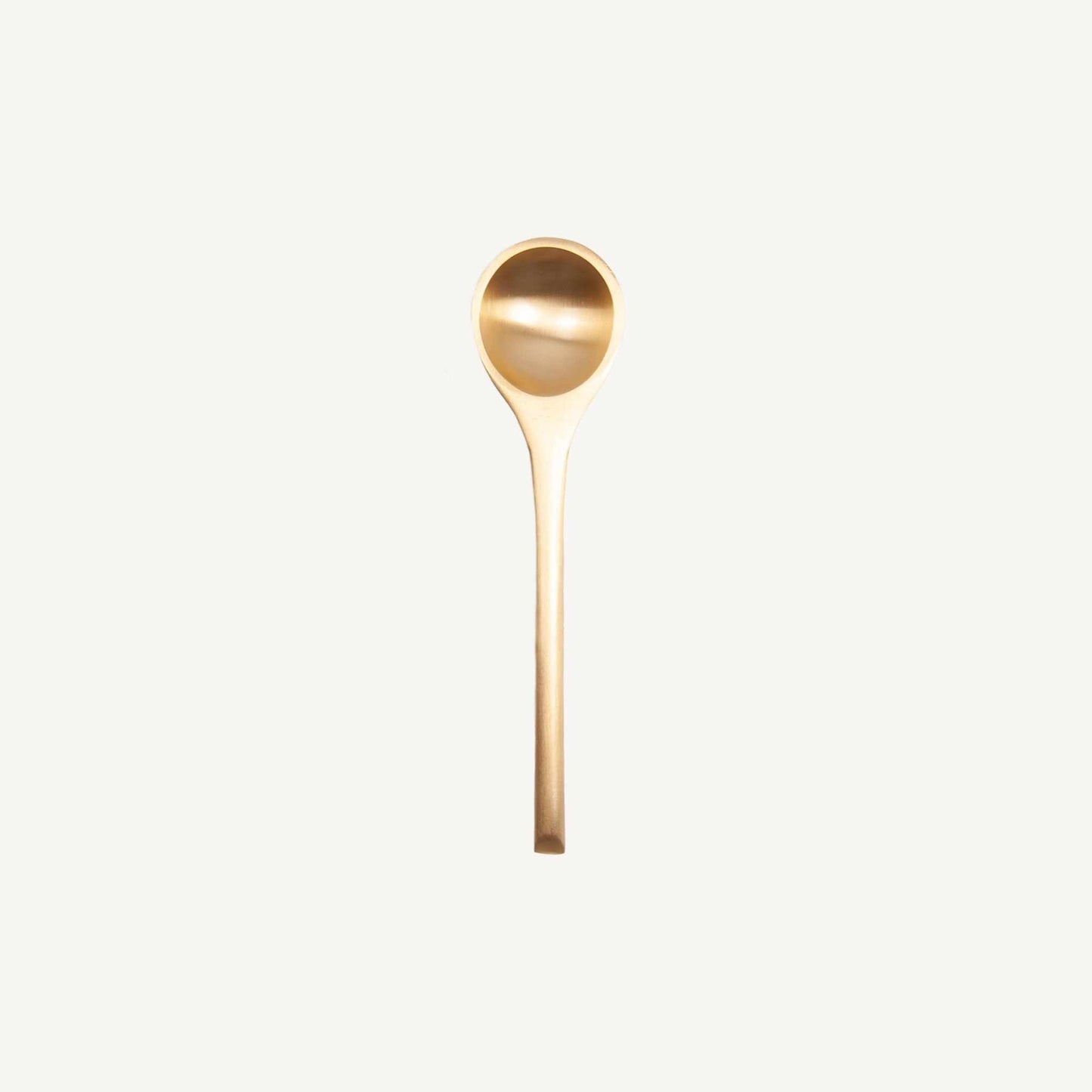 Solid brass spoon with a natural patina, durable and functional serving piece measuring 4.875 by 0.75 inches