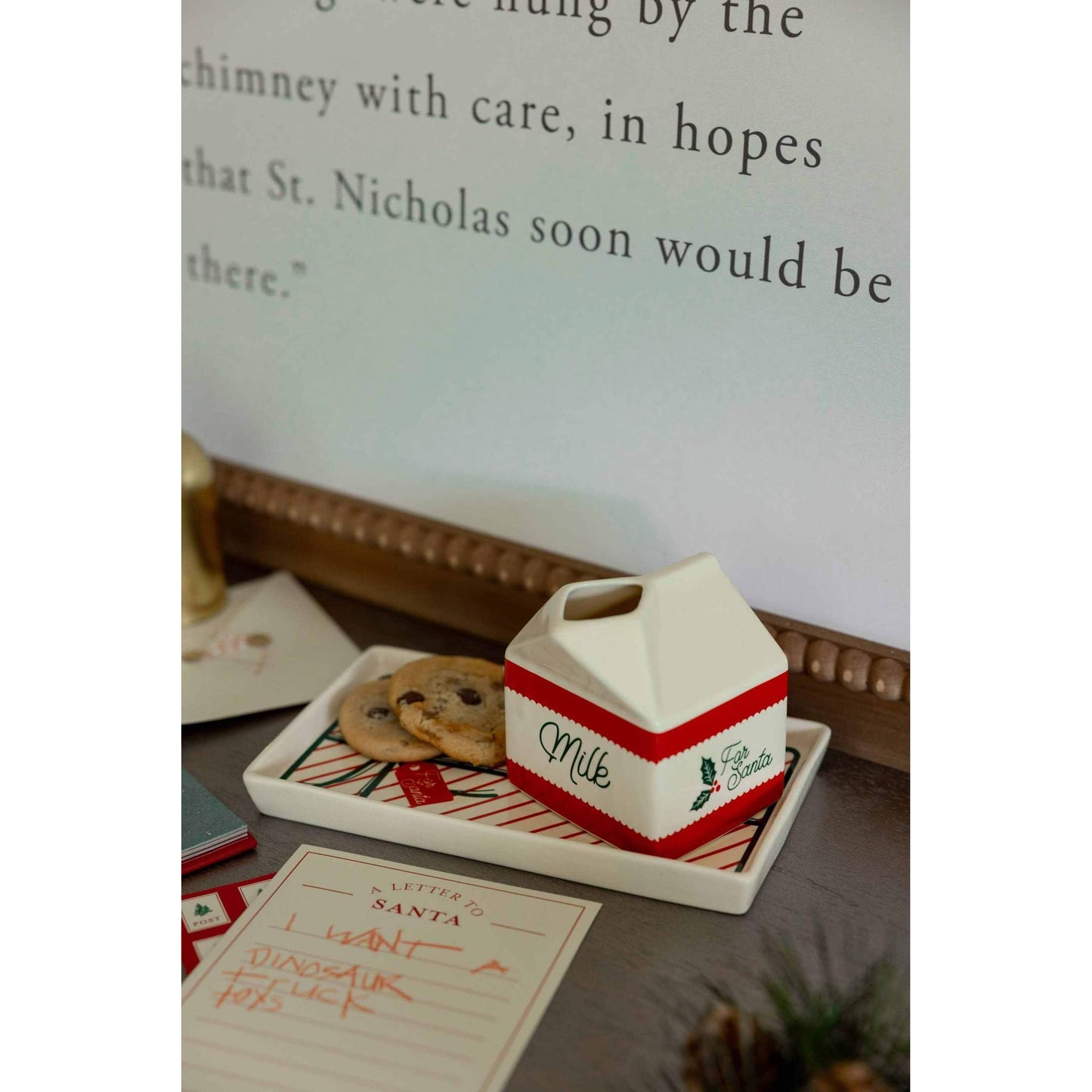 Milk and Cookies Set with festive ceramic cookie tray and milk jug decorated with holiday bow and Santa theme