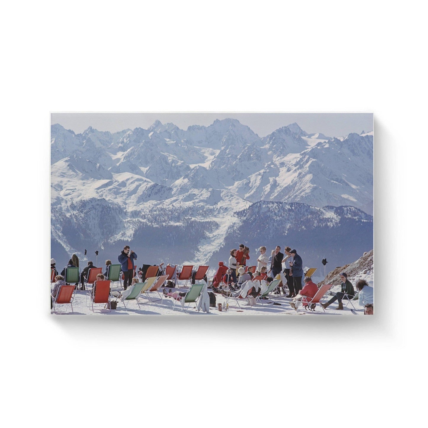 Ski party canvas wall art featuring people relaxing on deck chairs in snowy mountains by Slim Aarons, 12x16 inches premium canvas.