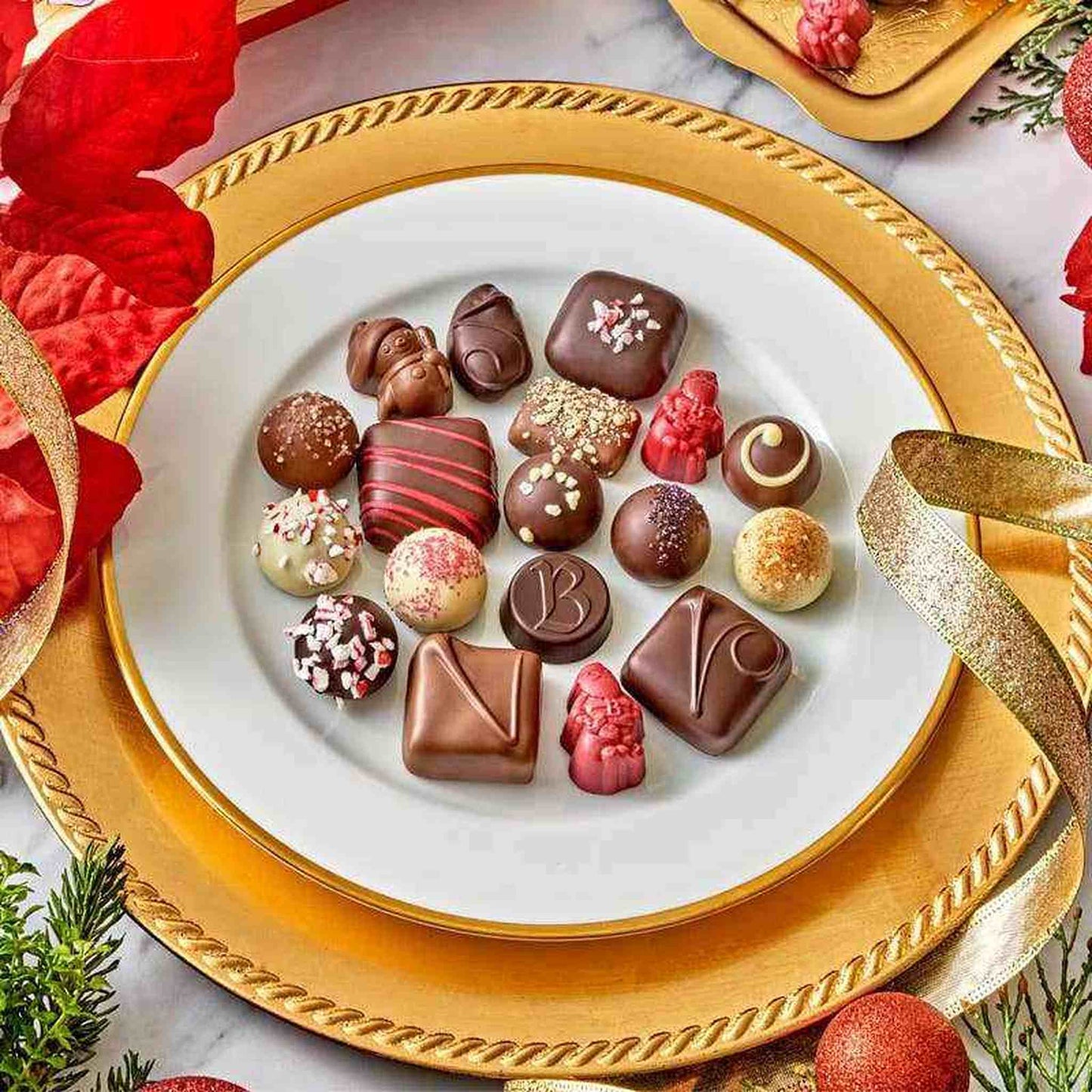 Bissinger's Assorted Noël à Paris festive gourmet chocolates on gold plate for Christmas 2024