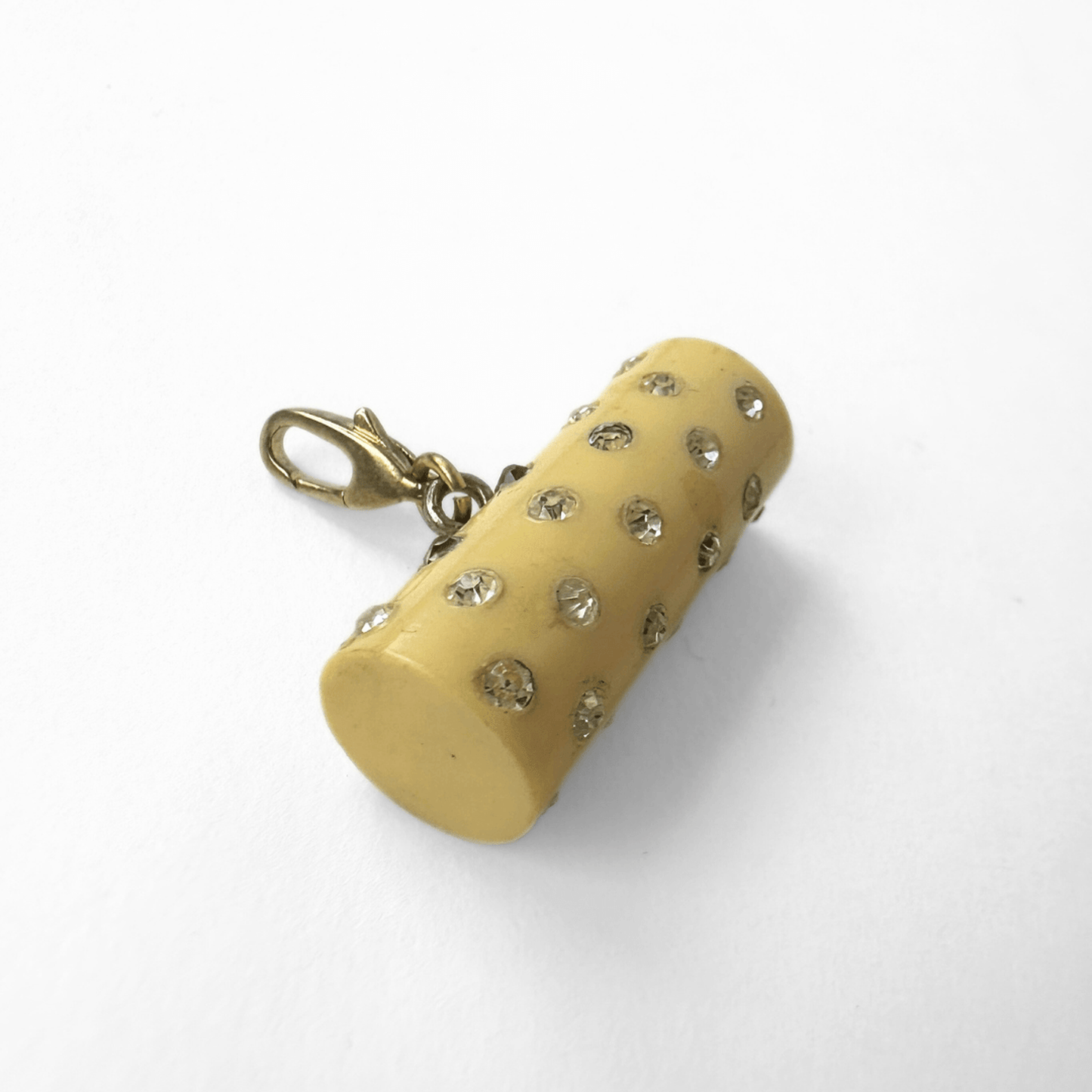 Vintage pale yellow rhinestone celluloid cylinder charm with brass lobster clasp