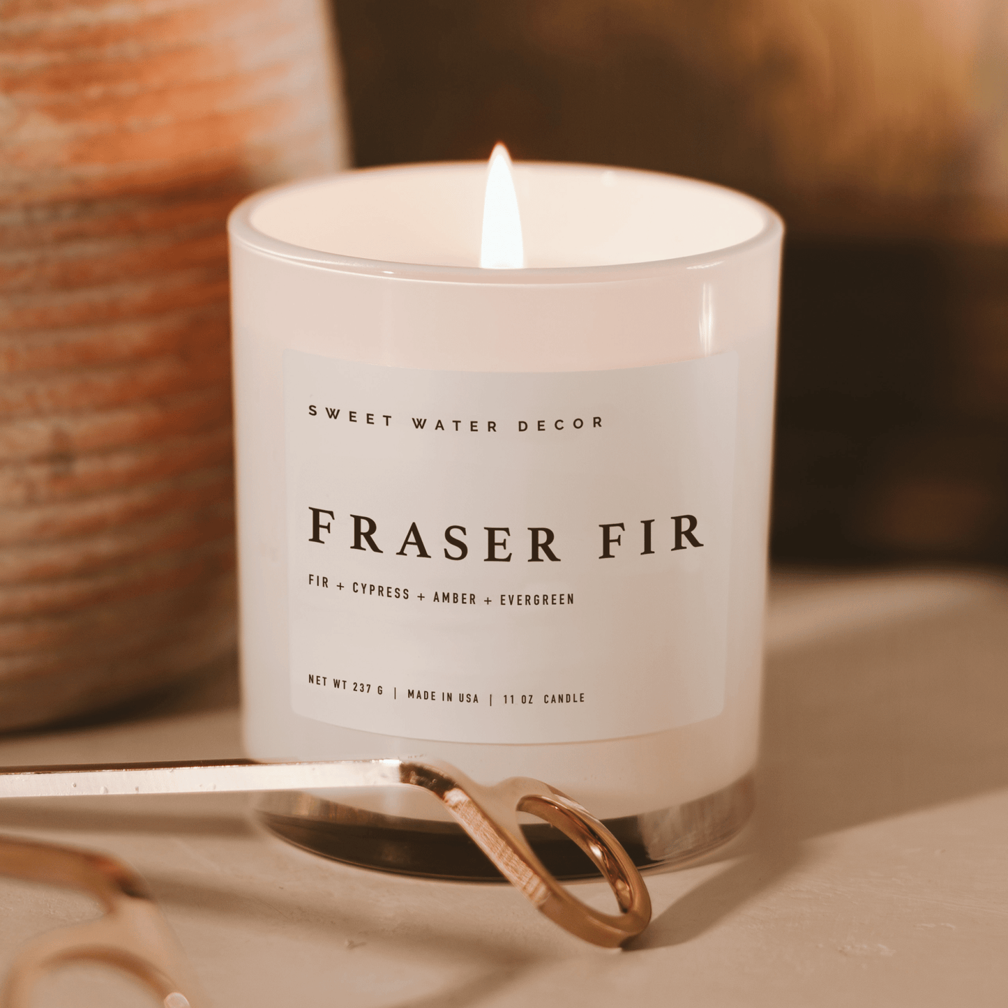 Fraser Fir soy candle in white glass jar with woodsy Christmas scent and cotton wick burning