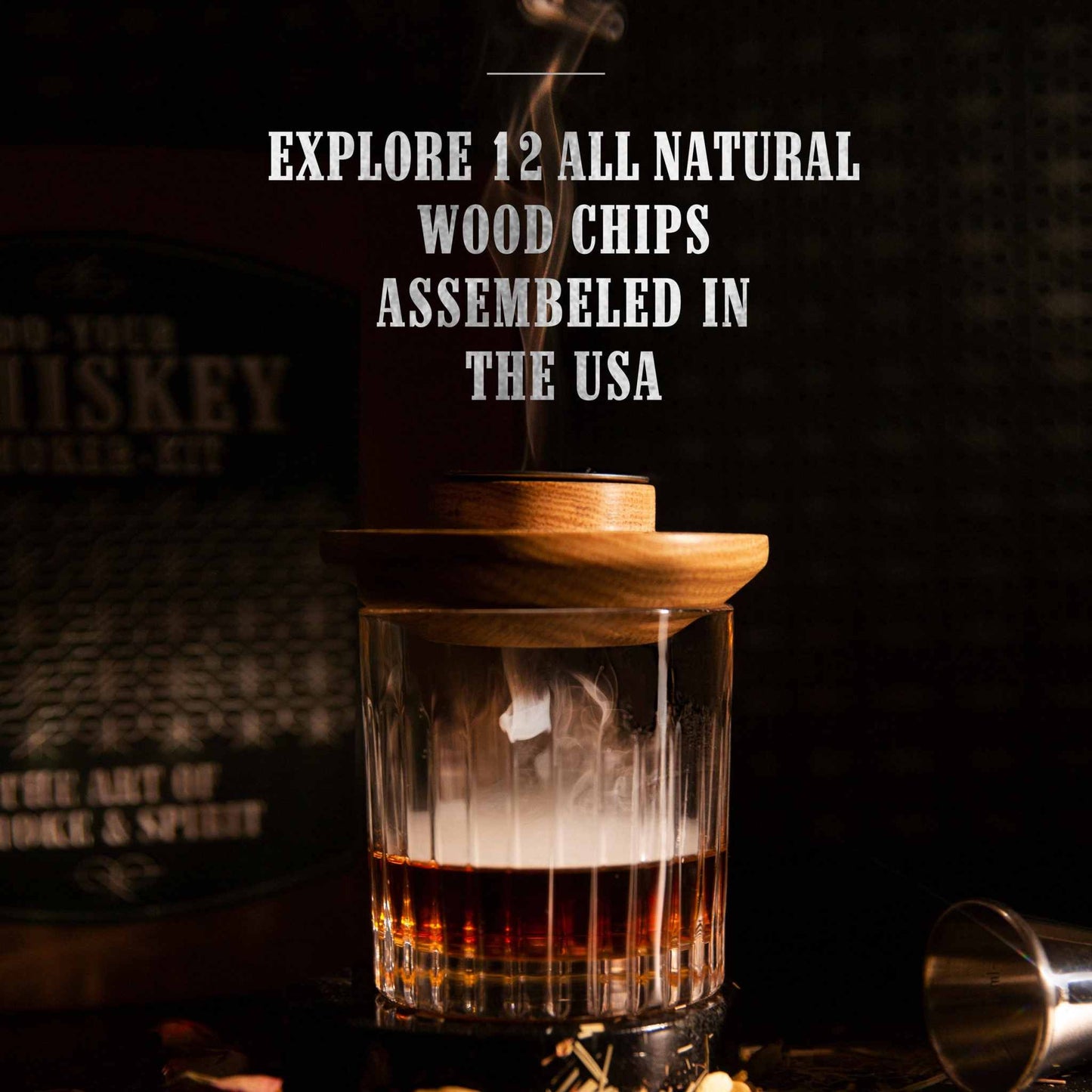 Whiskey smoker wood chips set with smoky glass of whiskey and wood lid smoking in dark setting