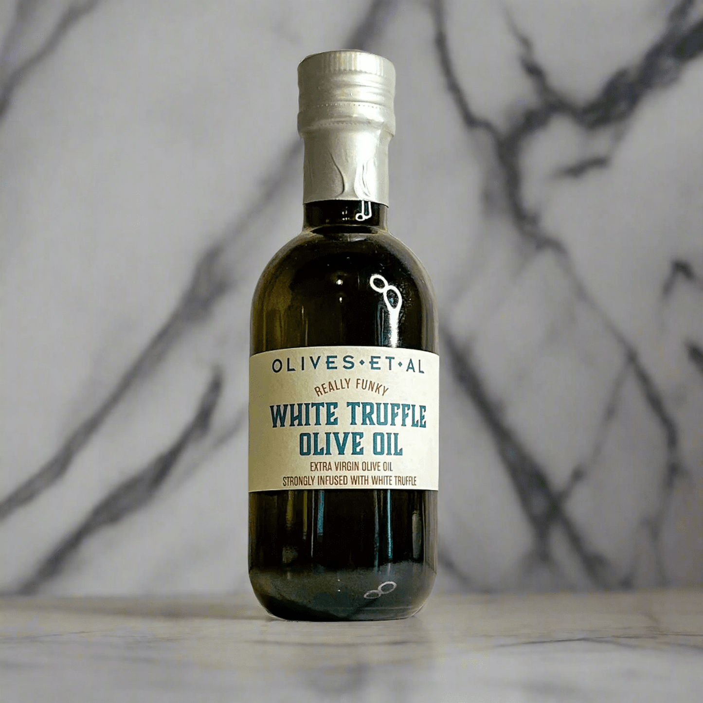 250ml bottle of White Truffle Olive Oil infused with extra virgin olive oil on marble surface