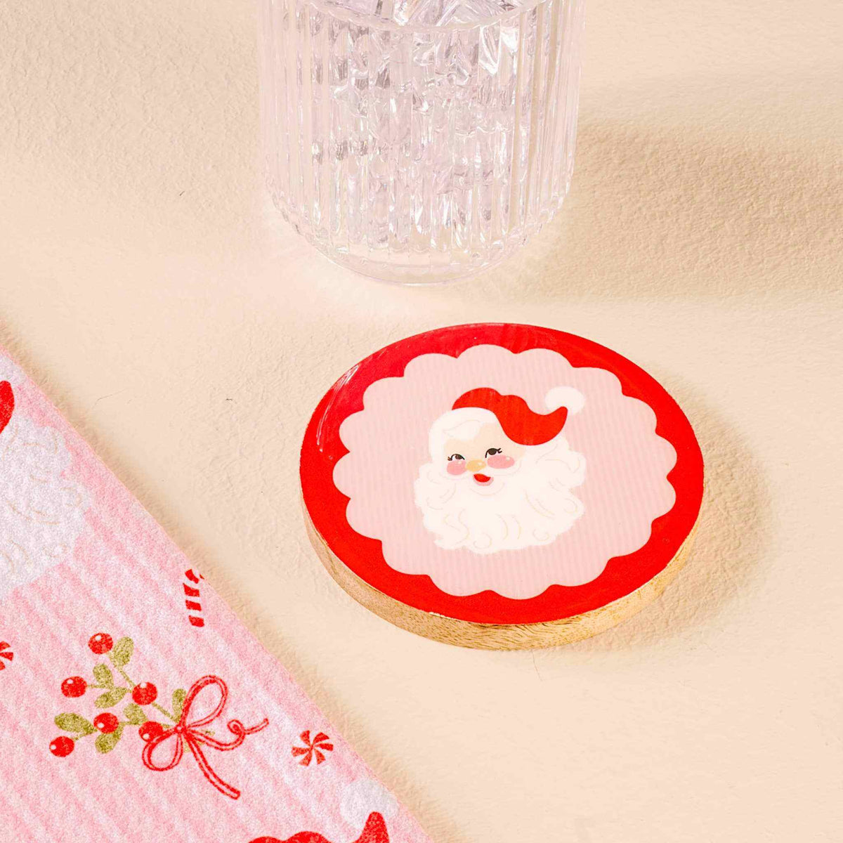 
                  
                    Wood enamel coaster with holly jolly Santa design, 4-inch diameter, durable and stylish surface protector
                  
                