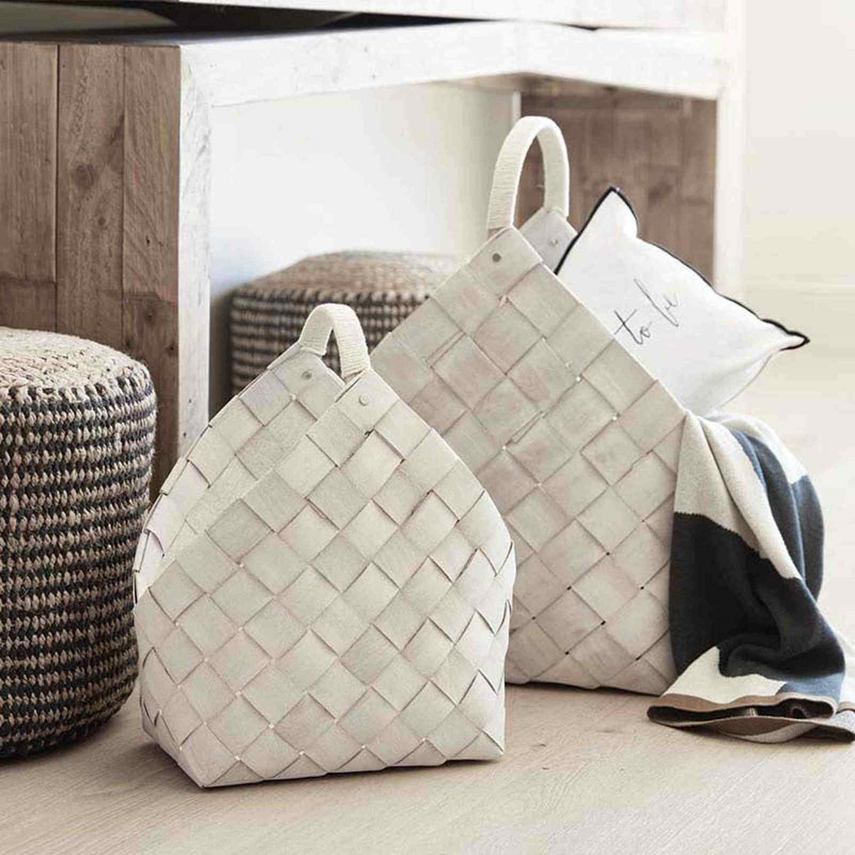 
                  
                    Set of two handcrafted nested wood fiber baskets in warm white for versatile home storage and décor.
                  
                