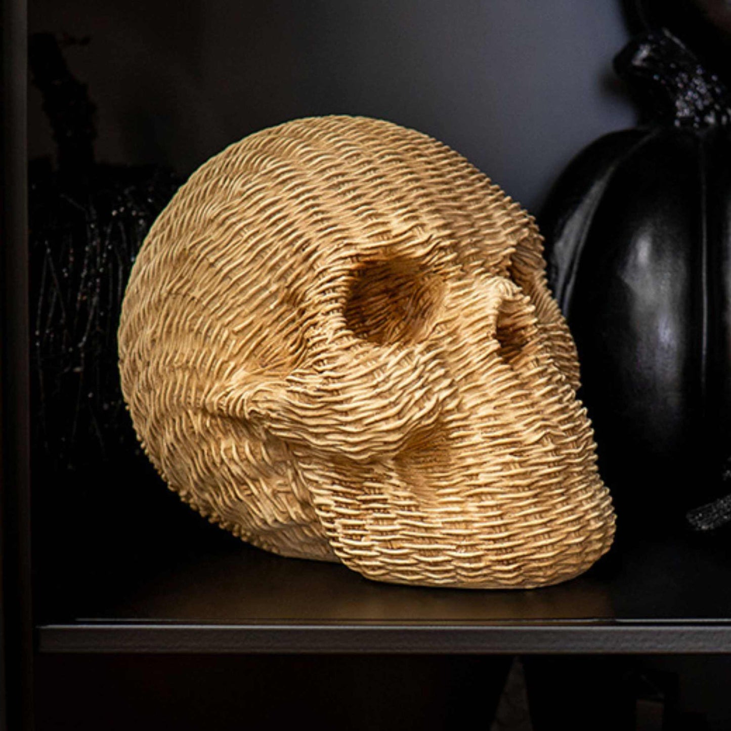 Wicker-look resin decorative skull in soft khaki with textured woven surface for seasonal decor