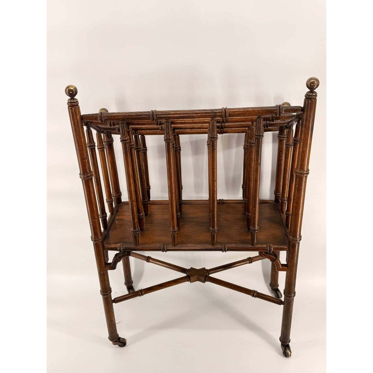 Vintage rolling faux bamboo wooden Canterbury magazine rack with multiple compartments and turned oak construction
