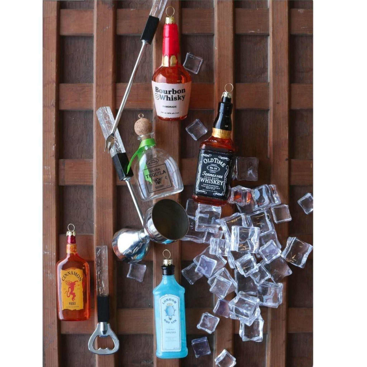 
                  
                    Glass tequila bottle ornament with festive ribbon and miniature ice cubes decoration
                  
                