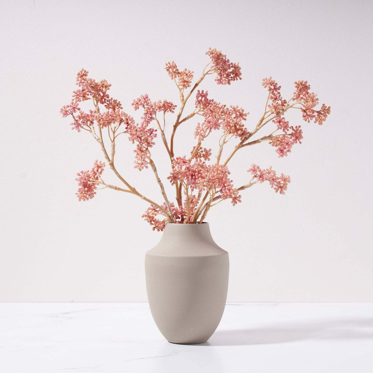 Beautyberry branch with pink buds in modern metal Milan vase