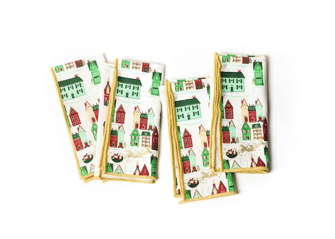 Set of four Flying Santa Dinner Napkins with 1950s holiday village design and gold stitched border