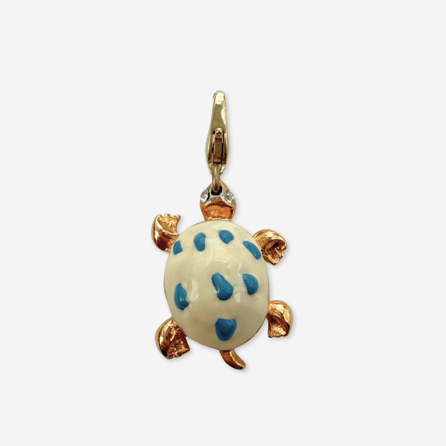 Vintage white and blue enamel turtle charm with gold body and rhinestone eyes on brass clasp