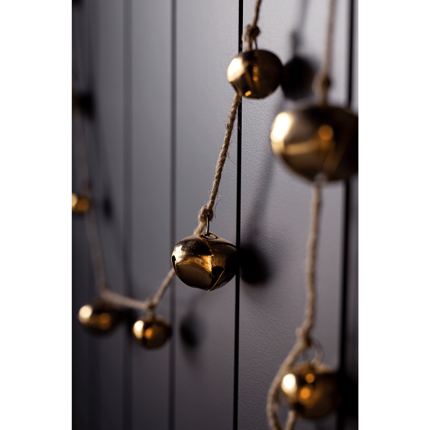 Jingle Iron Inspired Bell Garland with shiny brass bells on rustic twine for Christmas decor